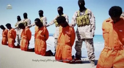 Islamic State militants stand behind what are said to be Ethiopian Christians along a beach in Wilayat Barqa, in this still image from an undated video made available on April 19, 2015.