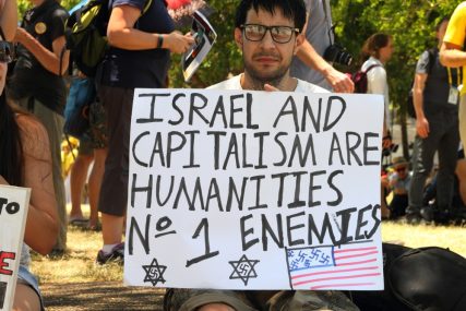 Unidentified protestor with an anti-Israel and capitalism protest sign on November 15, 2014 in Brisbane, Australia.