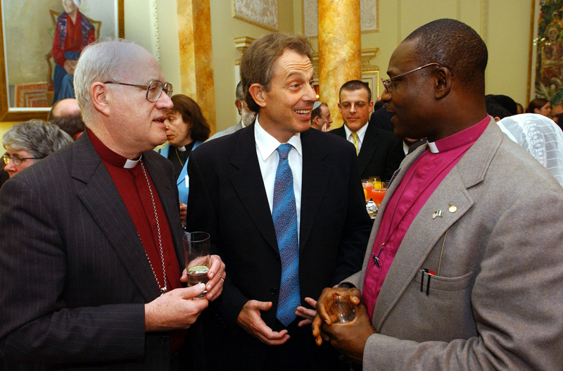 Britain's Prime Minister Tony Blair, center, talks to Archbishop of Canterbury Dr. George Carey, left and Rt. Revd. Josiah Idowu-Fearon, right, Bishop of Kaduna, Nigeria, at a reception in central London on January 17, 2002. Photo courtesy of REUTERS/Stephen Hird *Editors: This photo may only be republished with RNS-ANGLICAN-BISHOP, originally transmitted on April 13, 2015.