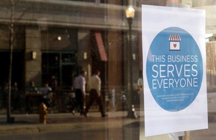 A sign reading "This business serves everyone" is placed in the window of Bernadette's Barbershop in downtown Lafayette, Indiana on March 31, 2015. The store is one of several who display a sticker stating "This business serves everyone." Indiana's Republican Governor Mike Pence, responding to national outrage over the state's new Religious Freedom Restoration Act, said on Tuesday he will "fix" it to make clear businesses cannot use the law to deny services to same-sex couples. Photo courtesy of REUTERS/Nate Chute