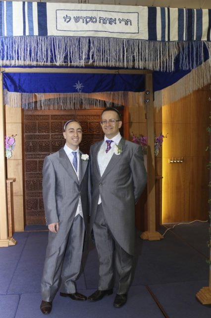 Eli Kaufman, left, with his husband Paul Ginsberg under the Chuppah during their wedding. Photo courtesy of Paul Ginsberg