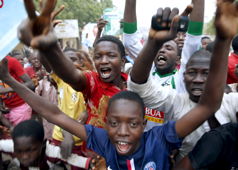 Supporters of the presidential candidate Muhammadu Buhari and his All Progressive Congress (APC) party celebrate in Kano on March 31, 2015. Three decades after seizing power in a military coup, Buhari became the first Nigerian to oust a president through the ballot box, putting him in charge of Africa's biggest economy and one of its most turbulent democracies. Photo courtesy of REUTERS/Goran Tomasevic  
*Editors: This photo may only be republished with RNS-NIGERIA-BUHARI, originally transmitted on April 1, 2015.