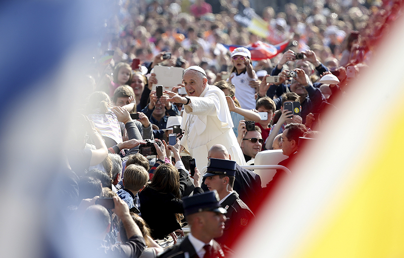 Pope Francis waves as he arrives to lead the general audience in St. Peter's Square at the Vatican on April 15, 2015. Photo courtesy of REUTERS/Alessandro Bianchi *Editors: This photo may only be republished with RNS-POPE-CLIMATE, originally transmitted on April 15, 2015.