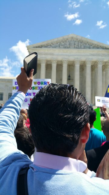 A man holds up a Bible in front of the Supreme Court on Tuesday, April 28, 2015, after justices hear arguments about same-sex marriage. Religion News Service photo by Kevin Eckstrom
