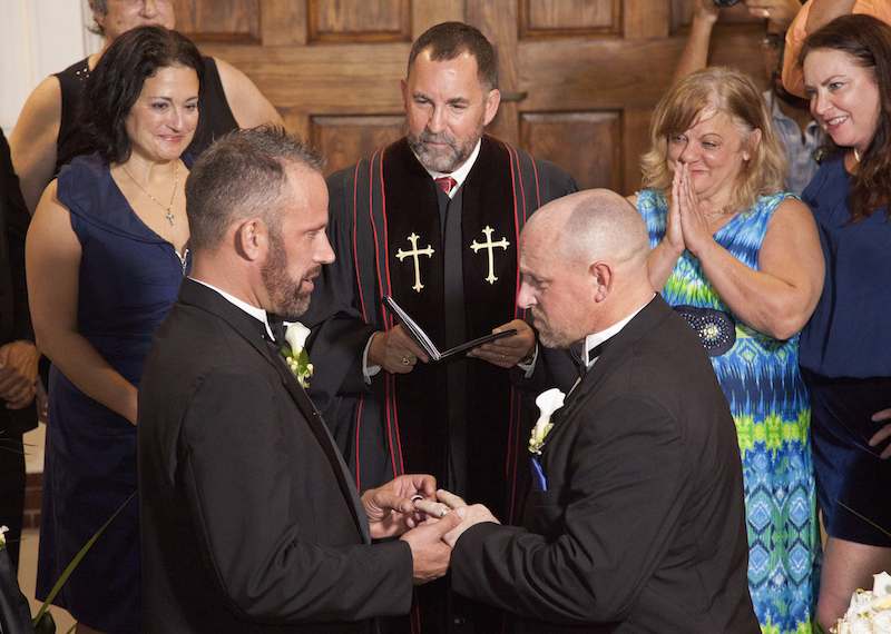 Aaron Huntsman (left) and William Lee Jones (right) are married in Key West, Fla., with the Rev. Steve Torrence officiating, the first couple to marry in the Florida Keys. Photo courtesy of REUTERS/Carol Tedesco/Florida Keys News Bureau // RNS-GAY-MARRIAGE, originally transmitted Jan. 28, 2015
