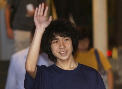 Amos Yee waves as he leaves the State Courts after his trial in Singapore May 12, 2015.
