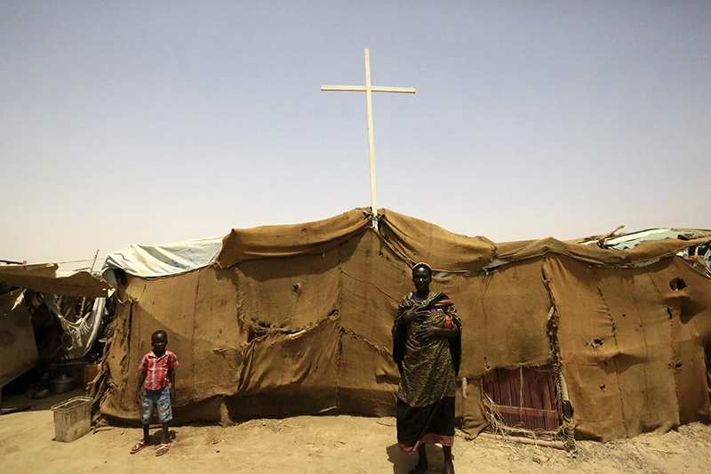 People from South Sudan stand near a tent used as a church at a railway station camp, where they have spent the last four years, in Khartoum May 11, 2014. Photo courtesy of REUTERS/Mohamed Nureldin Abdallah
*Editors: This photo may only be republis