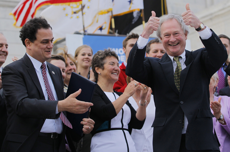 Rhode Island Governor Lincoln Chafee, right, gestures after signing the the Marriage Equality Act into law and handing it to Speaker Gordon Fox, left, at the State House in Providence, Rhode Island, on May 2, 2013. Photo courtesy of REUTERS/Jessica Rinaldi
*Editors: This photo may only be republished with RNS-CHAFEE-FAITH, originally transmitted on June 3, 2015.