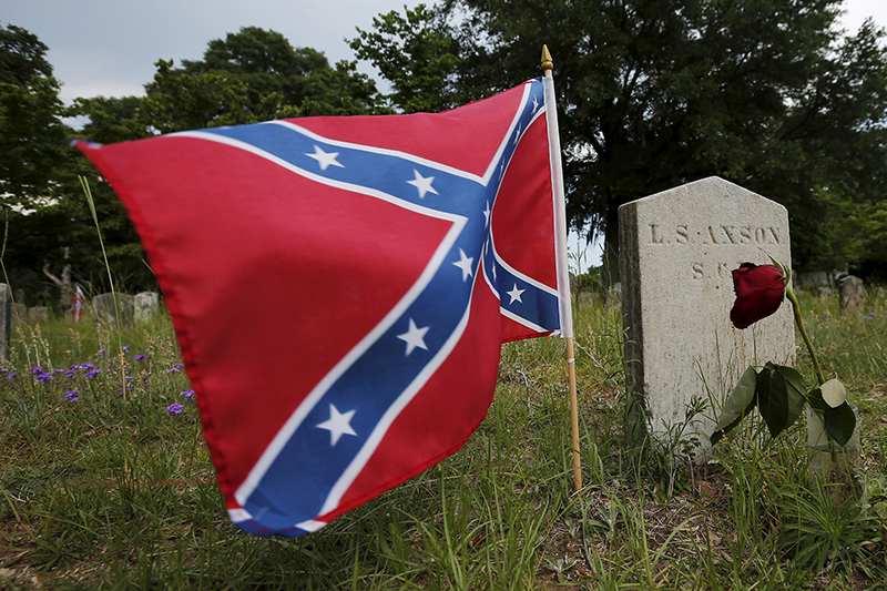 A Confederate battle flag flies at the grave of L.S. Axson, a soldier in the Confederate States Army in the U.S. Civil War, in Magnolia Cemetery in Charleston, South Carolina on June 22, 2015. Photo courtesy of REUTERS/Brian Snyder
*Editors: This photo may only be republished with RNS-CONFEDERATE-FAITH, originally transmitted on June 23, 2015.