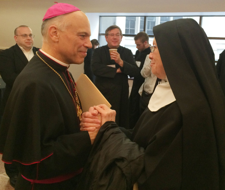 San Francisco Archbishop Salvatore Cordileone speaks with a nun after his talk on Wednesday, June 3, 2015 in New York in which he criticized 