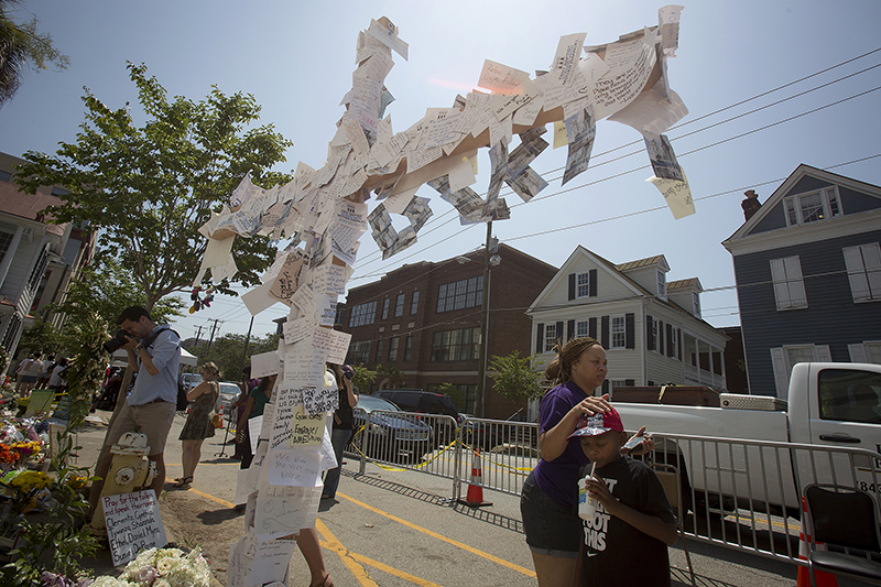A mother and son stand at a makeshift memorial for victims of a mass shooting, outside the Emanuel African Methodist Episcopal Church in Charleston, on June 22, 2015. Photo courtesy of REUTERS/Carlo Allegri *Editors: This photo may only be republished with RNS-GUSHEE-COLUMN, originally transmitted on June 24, 2015.