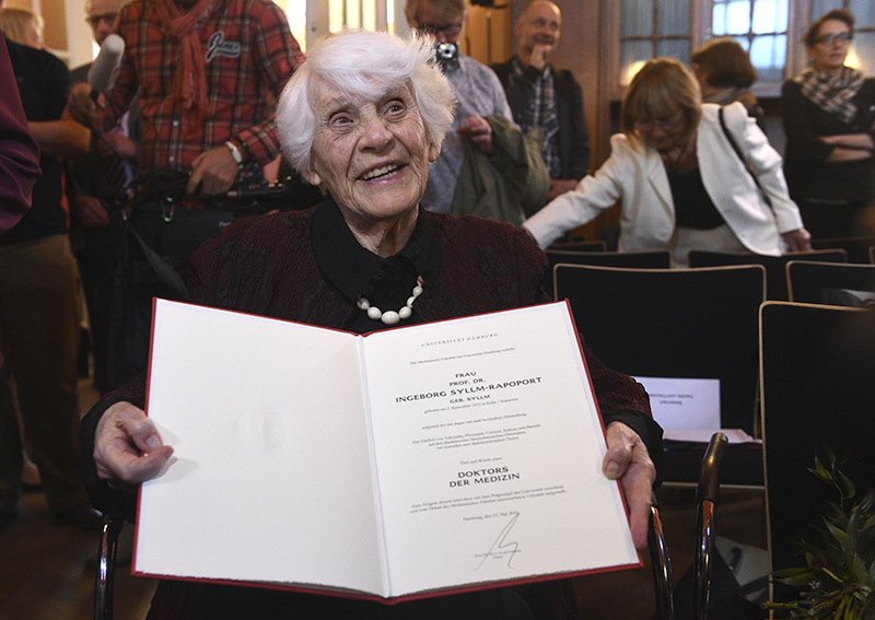 Retired German neonatologist Ingeborg Syllm-Rapoport, aged 102, poses with her doctoral certificate at the UKE hospital in Hamburg, on June 9, 2015. From 1937 until 1938 Syllm-Rapoport studied medicine in Hamburg, but the admission to her oral exam was denied by the Nazi authorities due to her Jewish origin. Some 77 years later Syllm-Rapoport took her oral exam and passed it successfully on May 20, 2015. Photo courtesy of REUTERS/Fabian Bimmer 
*Editors: This photo may only be republished with RNS-JEWISH-PHD, originally transmitted on June 11, 2015.