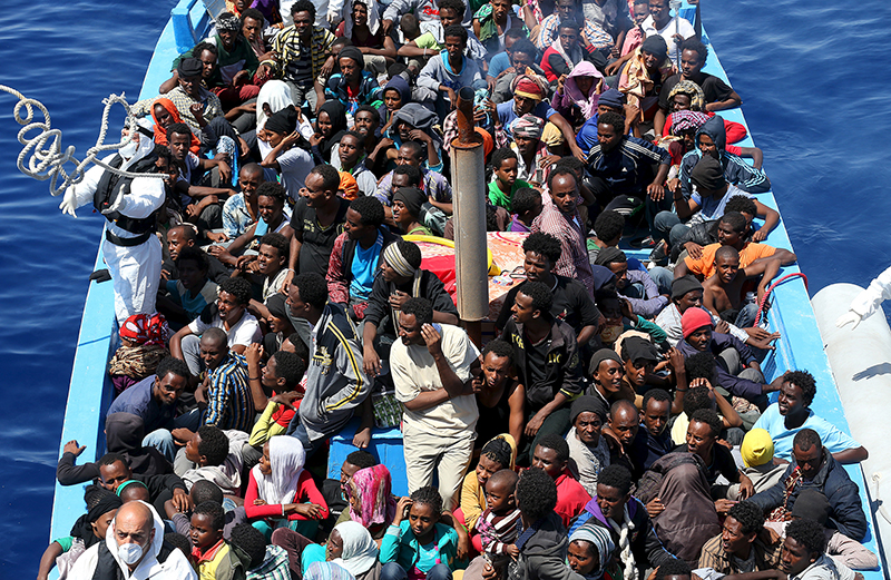 A group of 300 sub-Saharan Africans sit in board a boat during a rescue operation by the Italian Finance Police vessel Di Bartolo (not pictured) off the coast of Sicily, on May 14, 2015. Around 1100 migrants were rescued off the coast of Sicily, about 130 miles from Lampedusa, according to the police. Photo courtesy of REUTERS/Alessandro Bianchi 
*Editors: This photo may only be republished with RNS-POPE-IMMIGRANTS, originally transmitted on June 17, 2015.