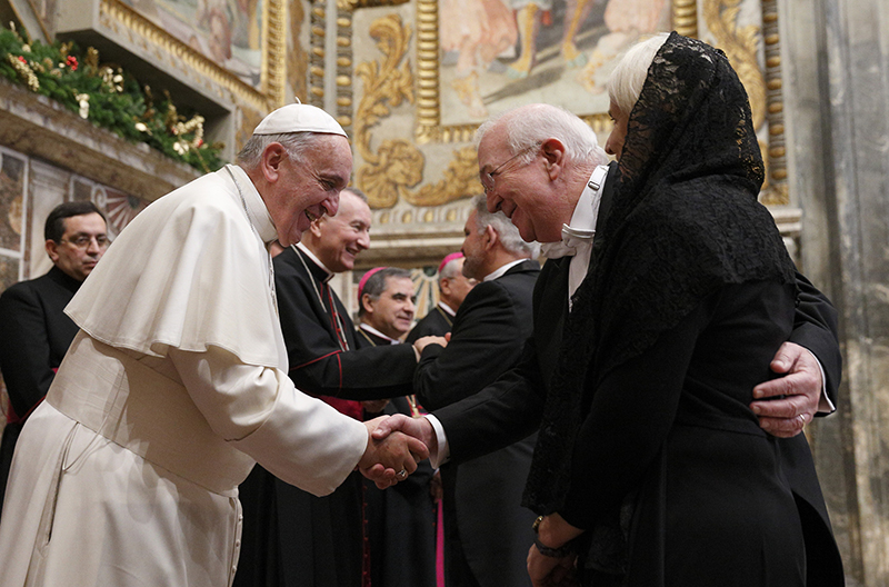 Pope Francis exchanges greetings with Ken Hackett, U.S. ambassador to the Holy See, and his wife, Joan, during a meeting with ambassadors to the Holy See at the Vatican on Jan. 13, 2014. Photo by Paul Haring, courtesy of Catholic News Service