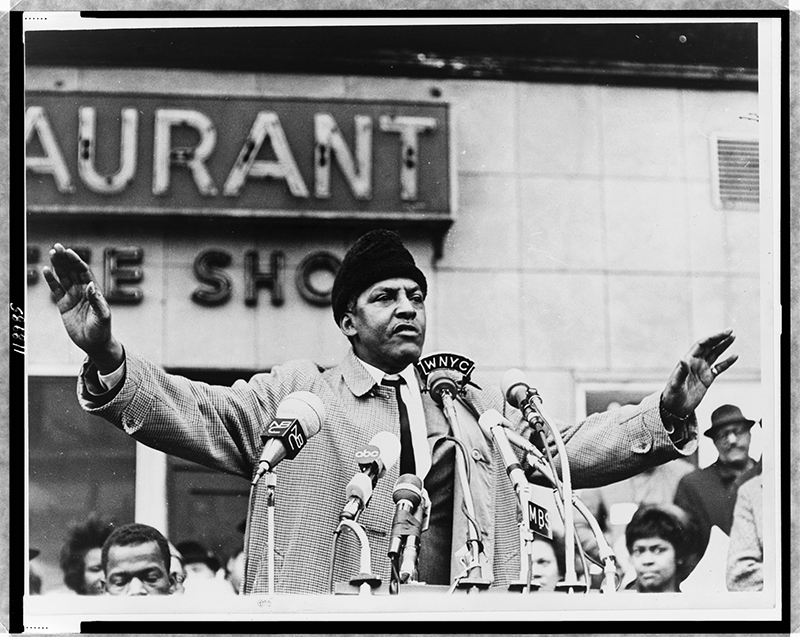 Bayard Rustin speaks to the media in 1965. World Telegram & Sun photo by Stanley Wolfson, courtesy of Library of Congress (Public Domain)