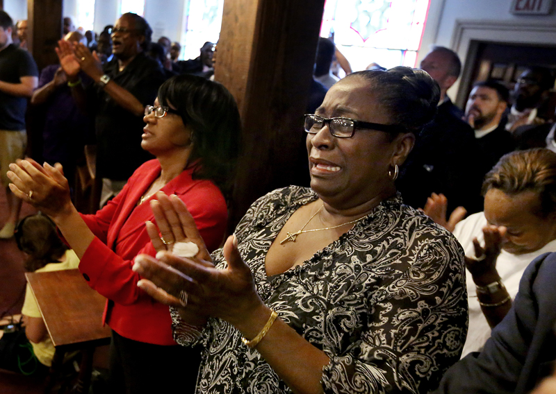 Rev. Jeannie Smalls cries during a prayer vigil held at Morris Brown AME Church in Charleston, South Carolina, on June 18, 2015. A white man suspected of killing nine people in a Bible-study group at a historic African-American church in Charleston, South Carolina was arrested on Thursday and U.S. officials are investigating the attack as a hate crime. Photo courtesy of REUTERS/Grace Beahm/Pool