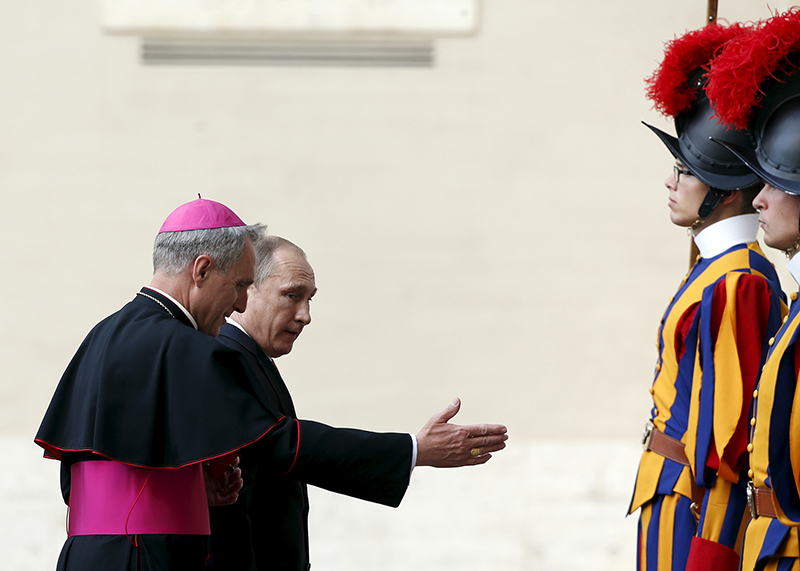 Russian President Vladimir Putin is welcomed by bishop Georg Ganswein as he arrives for a private audience with Pope Francis, in Vatican City on June 10, 2015. The United States urged the Vatican on Wednesday to criticise Russia's involvement in the Ukraine conflict more forcefully, hours before Pope Francis was due to meet Russian President Vladimir Putin. Photo courtesy of REUTERS/Alessandro Bianchi
*Editors: This photo may only be republished with RNS-PUTIN-VATICAN, originally transmitted on June 11, 2015.