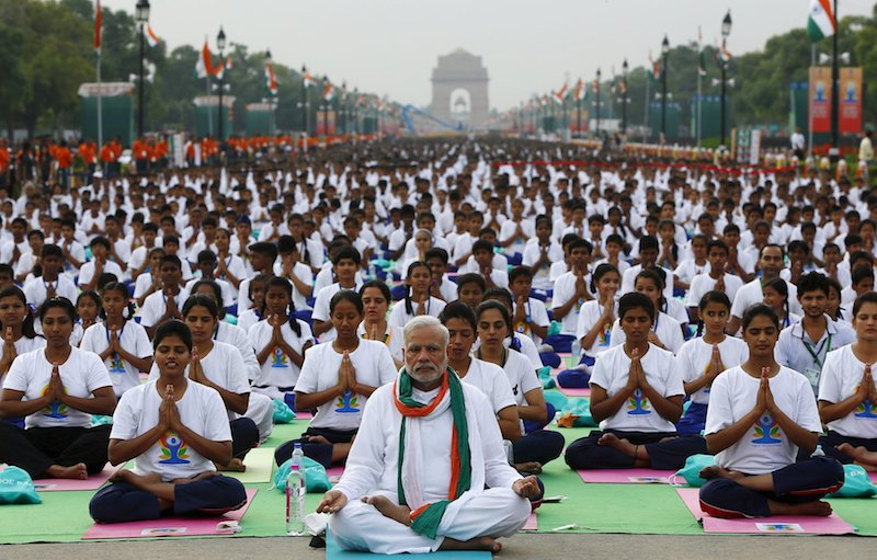 India's Prime Minister Narendra Modi performs yoga with others to mark the International Day of Yoga, in New Delhi, India, June 21, 2015. Photo by Adnan Abidi courtesy of Reuters