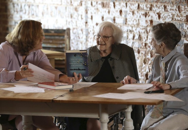 American author Harper Lee speaks with documentary filmmaker and author Mary McDonagh Murphy (L) and family friend Joy Brown (R) prior to the publication of 