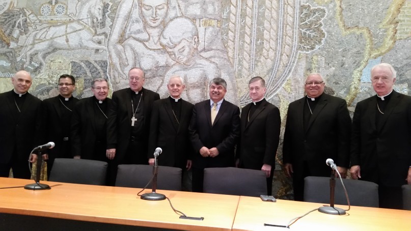 AFL-CIO President Richard Trumka flanked by eight Catholic bishops. Religion News Service photo by Mark Silk