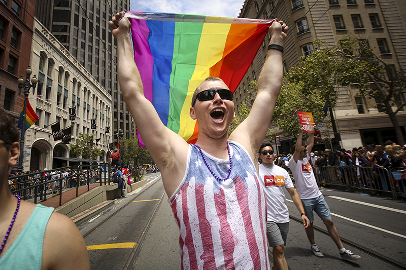 A man waves a rainbow flag while marching in the San Francisco gay pride parade two days after the U.S. Supreme Court's landmark decision that legalized same-sex marriage throughout the country in San Francisco, Calif., on June 28, 2015. Photo courtesy of REUTERS/Elijah Nouvelage *Editors: This photo may only be republished with RNS-ABORTION-MARRIAGE, originally transmitted on July 2, 2015.