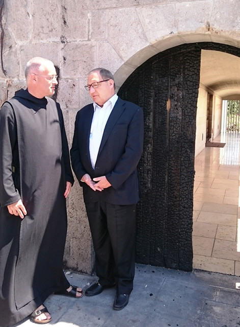 The Rev. Matthias Karl, left, the leader of the Church of the Multiplication of the Loaves and Fishes in the Galilee, and Anti-Defamation League National Director Abraham Foxman discuss on June 30, 2015 recent damage to the church caused by arsonists. The ADL presented a check to the church to help fund fire-related expenses. Photo courtesy of Anti-Defamation League