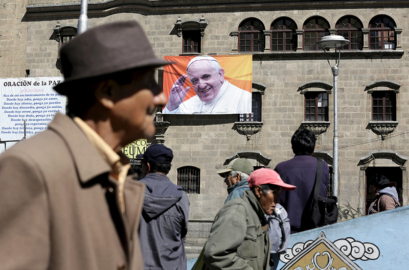 Pedestrians walk around San Francisco square, where an image of Pope Francis is displayed in La Paz on June 30, 2015. Photo courtesy of REUTERS/David Mercado
*Editors: This photo may only be republished with RNS-LATIN-TRIP, originally transmitted on July 2, 2015.