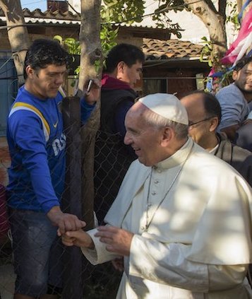 Pope Francis is greeted by a faithful during his visit to the Banado Norte neighborhood in Asuncion, Paraguay, July 12, 2015. Picture taken July 12, 2015.  REUTERS/Osservatore Romano     ATTENTION EDITORS - THIS PICTURE WAS PROVIDED BY A THIRD PARTY. REUTERS IS UNABLE TO INDEPENDENTLY VERIFY THE AUTHENTICITY, CONTENT, LOCATION OR DATE OF THIS IMAGE. FOR EDITORIAL USE ONLY. NOT FOR SALE FOR MARKETING OR ADVERTISING CAMPAIGNS. NO SALES. NO ARCHIVES. THIS PICTURE IS DISTRIBUTED EXACTLY AS RECEIVED BY REUTERS, AS A SERVICE TO CLIENTS.