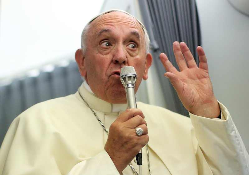 Pope Francis speaks to journalists onboard the papal plane during his return to Rome, from Asuncion, Paraguay on July 12, 2015. Photo by Alessandro Bianchi, courtesy of Reuters