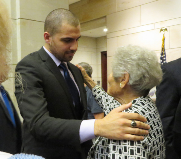 Damascus native and Syrian refugee Qutaiba Y. Idbli, left, embraces Holocaust survivor Margit Meissner after speaking at the opening of "Caesar’s Photos: Inside Syria’s Secret Prisons," at the U.S. Capitol building in Washington, D.C., on Wednesday (July 15, 2015). Religion News Service photo by Sara Weissman