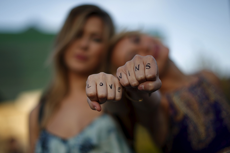 Cherilyn Wilson, 26, left, and Chelsea Kane, 26, display their fists, with the message "Love Wins" written on them, as they pose at a celebration rally in West Hollywood, California, United States, on June 26, 2015. Photo courtesy of REUTERS/Lucy Nicholson *Editors: This photo may only be republished with RNS-TRINKO-COMMENTARY, originally transmitted on July 7, 2015.