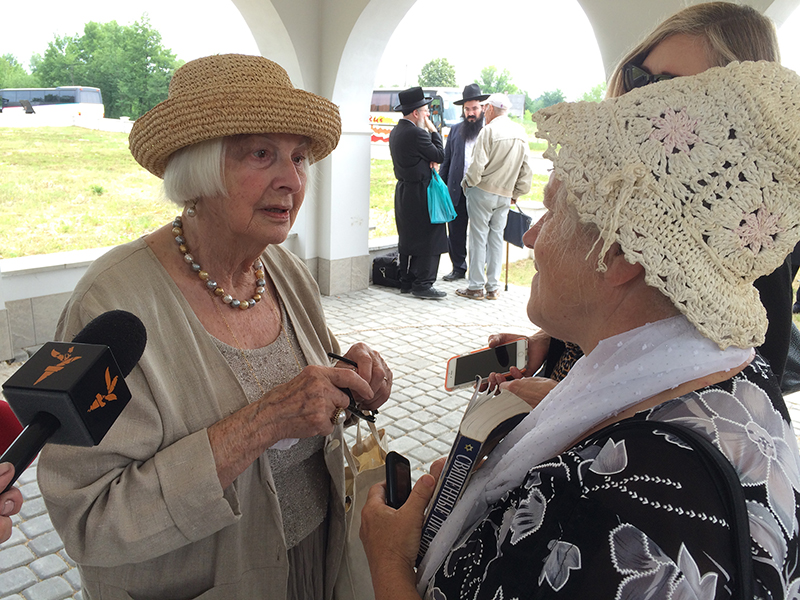 Ludvika Sarah Leah Schein, left, a survivor of the Holocaust in Rava-Ruska, talks to local woman at Rava-Ruska monument on June 29, 2015. She traveled from San Francisco to attend the dedication. Religion News Service photo by Michael Scaturro