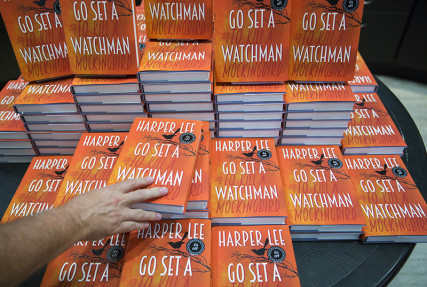 A customer picks up a copy of author Harper Lee's novel "Go Set a Watchman" at a Waterstones bookstore in London, Britain on July 14, 2015. "Go Set a Watchman" is the much-anticipated second novel by "To Kill a Mockingbird" author Harper Lee. Photo courtesy of REUTERS/Neil Hall