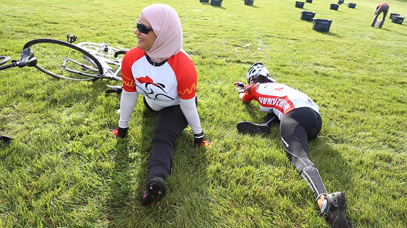 Amani Ammoura, left, a global cyclist from Jordan, and Rehab Shawky, a global cyclist from Egypt, stretch before the forth day of RAGBRAI, the Register's Annual Bicycle Ride Across Iowa, in Eldora, Iowa on July 22, 2015. Religion News Service photo by Sally Morrow
