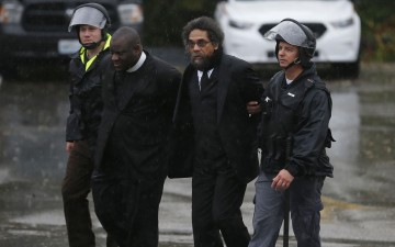 The Rev. Michael McBride, leader of the “Live Free Campaign” of PICO National Network, second left, is arrested. Photo courtesy of the Rev. Michael McBride