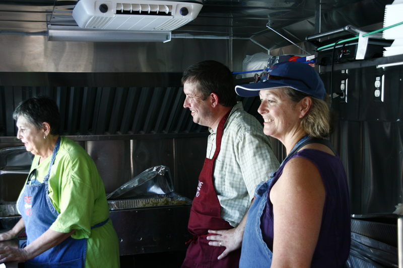 Allen Lutes, center, an associate minister at Arlington Heights United Methodist Church, and founder of its new ministry: Five & Two Food Truck, serves food with other volunteers. Religion News Service photo by Sarah Angle