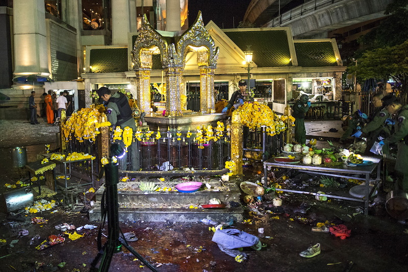 Experts investigate at the Erawan shrine, the site of a deadly blast in central Bangkok August 17, 2015. A bomb on a motorcycle exploded on Monday just outside a Hindu shrine in the Thai capital, killing 27 people, including foreign tourists, media reported, in an attack the government said was a bid to destroy the economy.   Photo courtesy REUTERS/Athit Perawongmetha