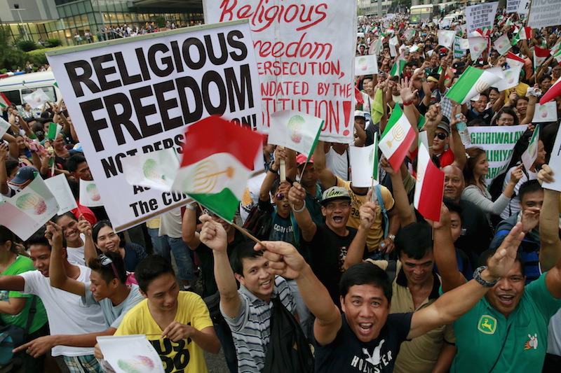 Protesters belonging to the Iglesia ni Cristo (Church of Christ) group display placards as they march along EDSA highway in Mandaluyong, Metro Manila August 30, 2015. Thousands of members of the Christian group occupied the busy highway in Manila for a second night on Saturday, protesting against what they say is government intrusion in church affairs. Photo courtesty REUTERS/Romeo Ranoco