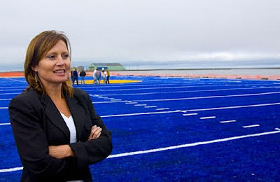 Cathy Parker, standing on the field named after her in Barrow, Alaska on August 17th, 2007, for first game the Whalers play on the newly installed artificial turf field. Courtesy of CineVantage Production