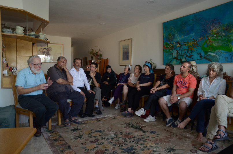 An interfaith group gathered in a private home on Sept. 21, 2015 to diffuse potential tensions over how Jews and Muslims celebrate Yom Kippur and Eid al-Adha, two holidays that overlap this year.  Two dozen people of various faiths heard a rabbi explain the laws and traditions of Yom Kippur, the Jewish Day of Atonement, and a Muslim sheikh explain the laws and traditions of Eid al-Adha, the Muslim holiday that honors the willingness of Ibrahim (the biblical Abraham) to heed God's order to sacrifice his son. Photo courtesy of The Abrahamic Reunion