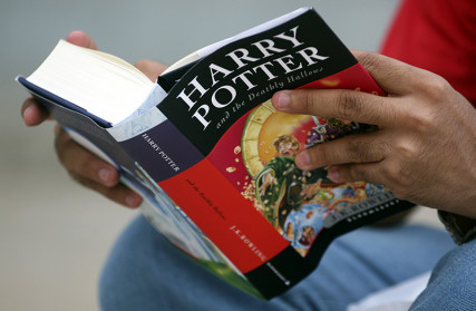 A fan reads "Harry Potter and the Deathly Hallows" by J.K. Rowling as he sits outside a bookstore in the western Indian city of Ahmedabad on July 21, 2007. Photo courtesy of REUTERS/Amit Dave *Editors: This photo may only be republished with RNS-BLASPHEMOUS-BOOKS, originally transmitted on Sept. 30, 2015.