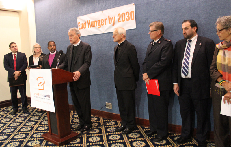 Faith leaders speak about their pledge to end world hunger by 2030 at a news conference at the National Press Club on September 22, 2015. Left to right, Rev. Gabriel Salguero, president, National Latino Evangelical Coalition; Rev. Sharon Watkins, president, Christian Church (Disciples of Christ); Bishop Lawrence Reddick III, presiding bishop of the Eighth Episcopal District of the Christian Methodist Episcopal Church, Rev. David Beckmann, president of Bread for the World; Cardinal Donald Wuerl, archbishop of Washington; Commissioner David Jeffrey, national commander, Salvation Army; Anwar Khan, chief executive officer, Islamic Relief;Ruth Messinger, president, American Jewish World Service. Religion News Service photo by Adelle M. Banks