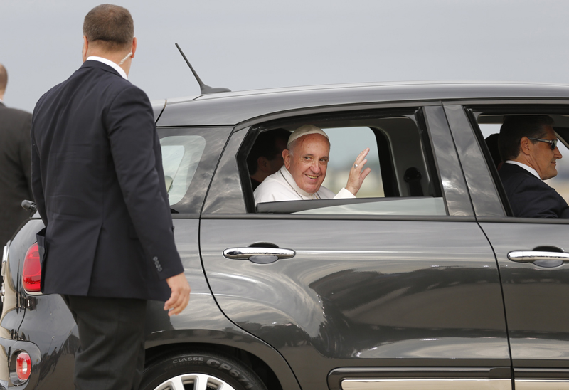 Pope Francis waves from a papal vehicle after arriving in the United States at Joint Base Andrews outside Washington on September 22, 2015. Photo courtesy of REUTERS/Jonathan Ernst