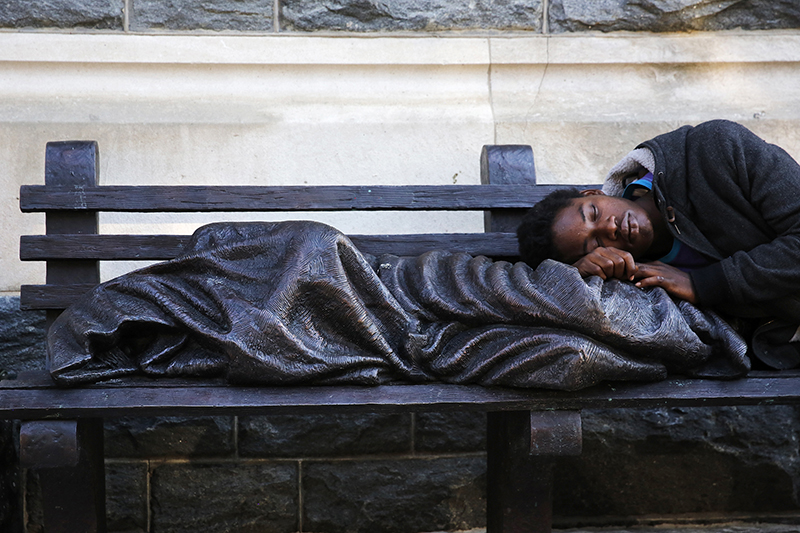 A man sleeps on a sculpture of a figure called 'Homeless Jesus' in front of the Archdiocese of Washington Catholic Charities offices in Washington, on September 16, 2015. Photo courtesy of REUTERS/Jonathan Ernst *Editors: This photo may only be republished with RNS-POPE-HOMELESS, originally transmitted on Sept. 24, 2015.