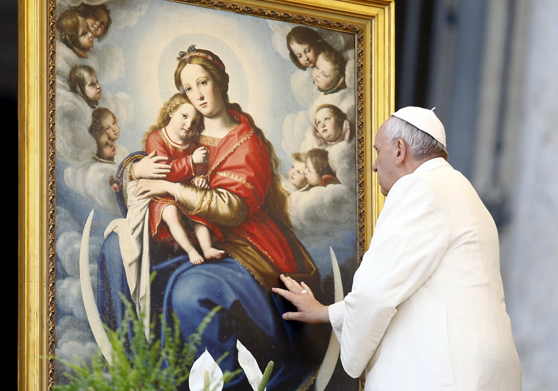 Pope Francis blesses a painting depicting the Virgin Mary with baby Jesus during the weekly audience in Saint Peter's square at the Vatican on March 25, 2015. Photo courtesy of REUTERS/Stefano Rellandini *Editors: This photo may only be republished with RNS-POPE-JESUS, originally transmitted on September 14, 2015.