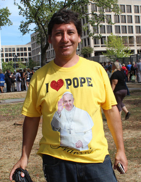 Eddy Barahona of Ashburn, Va., caught a glimpse of Pope Francis as he stood Constitution Avenue in Washington, D.C., when Francis rode by in a small black Fiat after addressing Congress on Sept. 24, 2015. Religion News Service photo by Adelle M. Banks