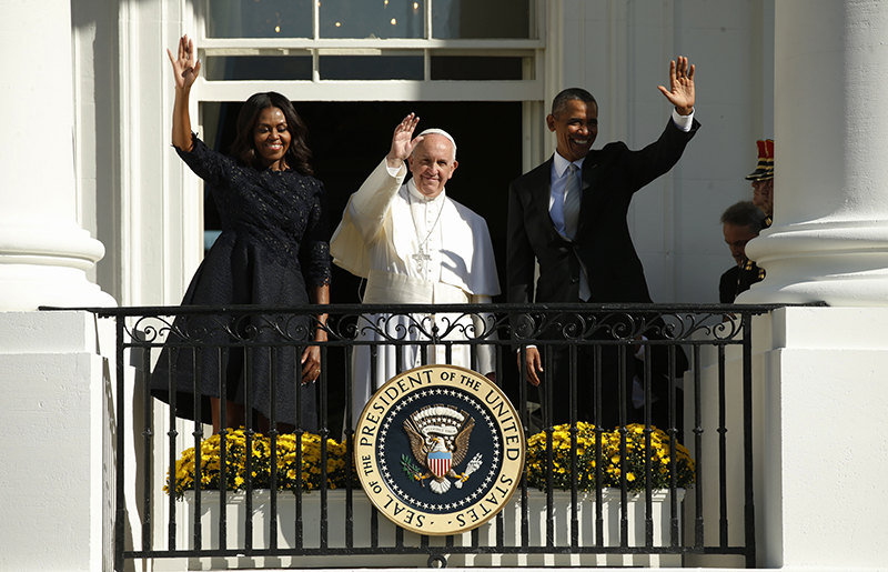 U.S. President Barack Obama and first lady Michelle Obama wave with Pope Francis during an arrival ceremony for the pope at the White House in Washington on September 23, 2015. The pontiff is on his first visit to the United States. Photo courtesy of REUTERS/Kevin Lamarque