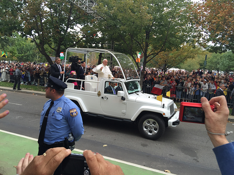 Pope Francis passes the crowd along the street of Philadelphia on September 27, 2015. Religion News Service by Kimberly Winston