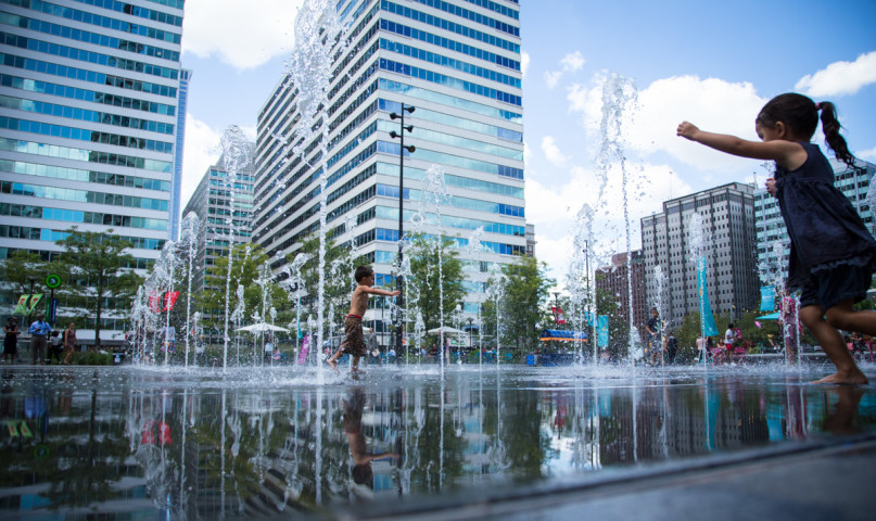 Children play in the fountain at Dilworth Park, surrounded by city buildings, in Philadelphia, Pa., on August 28, 2015, a month before Pope Francis plans to visit the city. Religion News Service photo by Sally Morrow