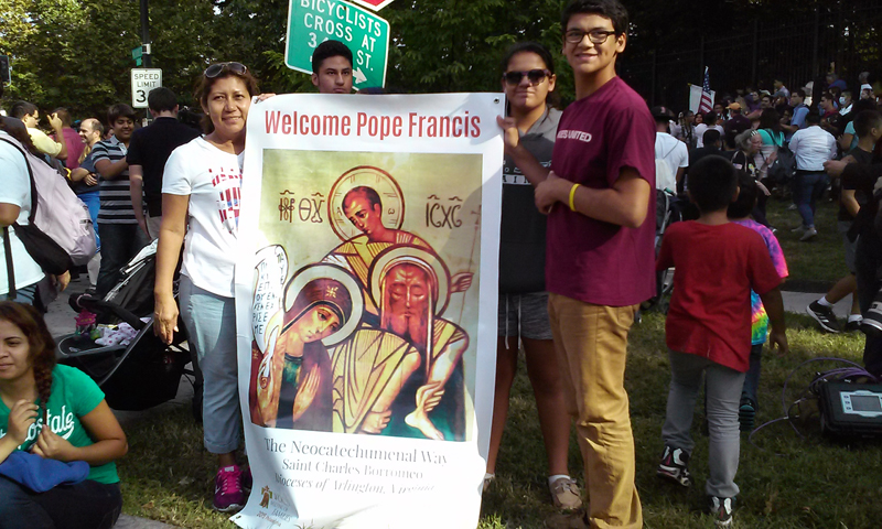 Left to right, Teresa Guzman of Alexandria, Deborah Cornejo, Gabrial Cornejo, both of Herndon, Va., hold a sign welcoming Pope Francis outside the Vatican embassy in Washington, D.C., on Sept. 22, 2015. Religion News Service photo by Adelle M. Banks